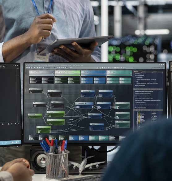 Close up of data center programmers using PC to visualize AI neural networks Close up of data center programmers using PC to visualize artificial intelligence neural networks. Server farm IT experts looking at monitor, working together to oversee AI systems