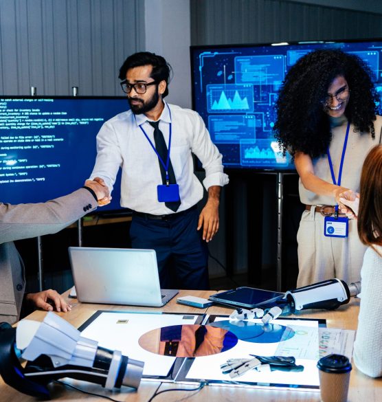 Team handshake during AI presentation at the meeting Diverse tech team handshake during AI project presentation in office. Professional software engineer and developer cooperate on artificial intelligence network cybersecurity system agreement success
